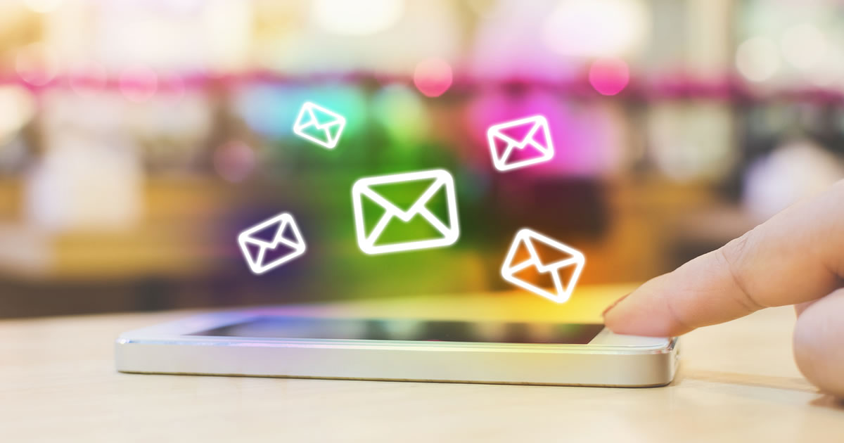 Woman&rsquo;s hand using mobile smartphone with email application and five email icons floating above it