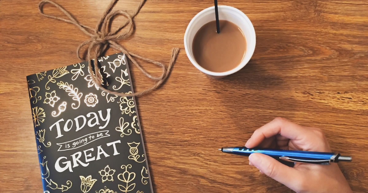 Journal titled &ldquo;Today is going to be great&rdquo; and a cup of coffee