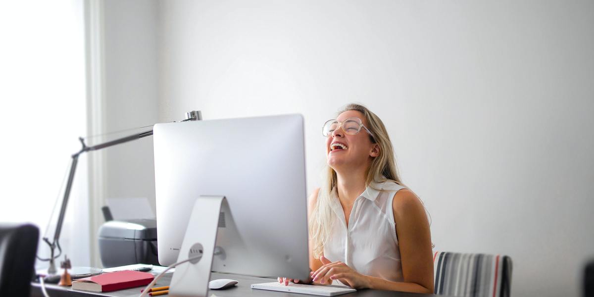 Woman having fun and smiling virtually talking to someone on computer