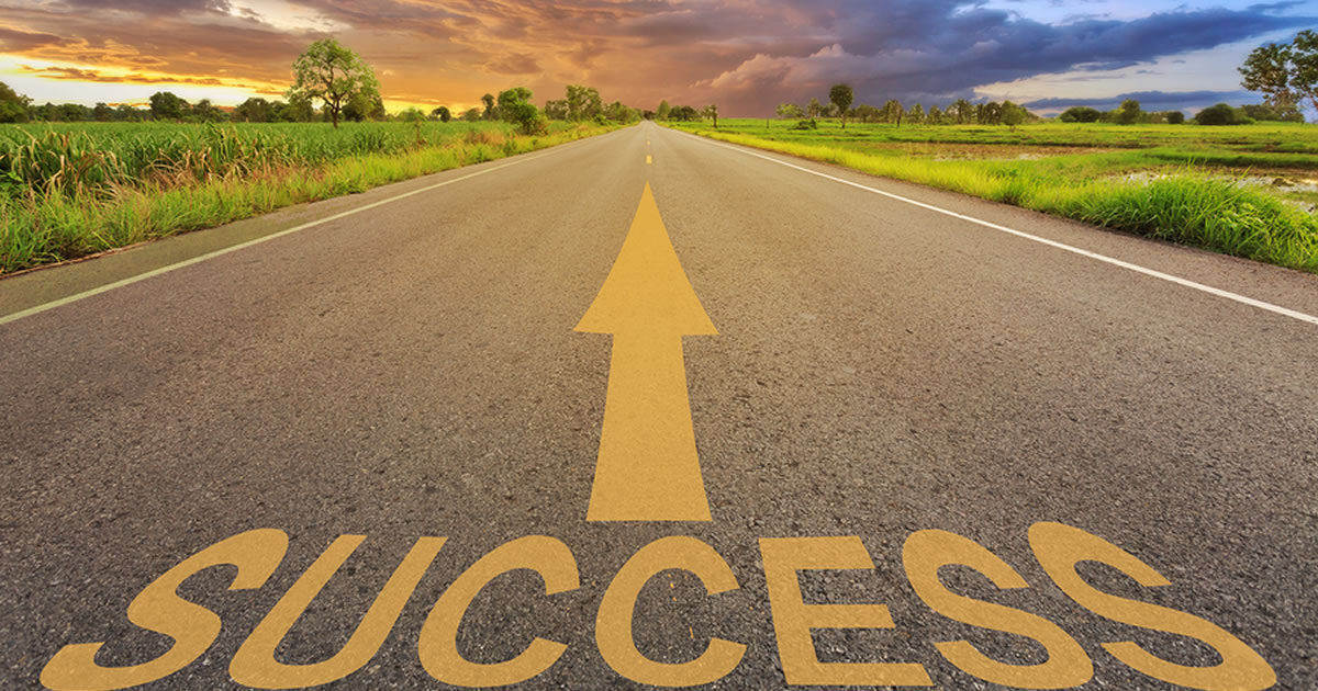 Road with an arrow pointing in the direction of the word success