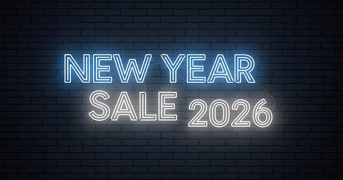 Glowing neon-style text reading &ldquo;New Year Sale 2026&rdquo; against a dark brick wall background.